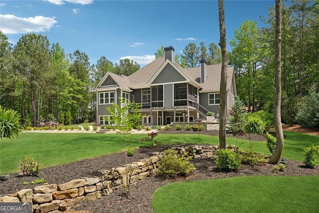 116 Serenity Lake Dr, Alpharetta, GA 30004 - rear view of property with a sunroom, a chimney, a yard, and roof with shingles