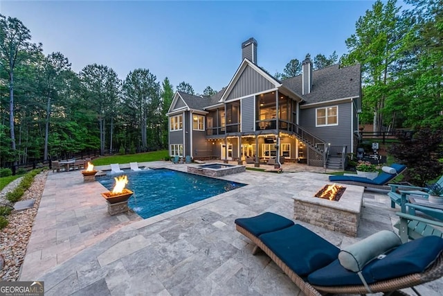 116 Serenity Lake Dr, Alpharetta, GA 30004 - rear view of property with a fire pit, a patio, stairway, a sunroom, and board and batten siding