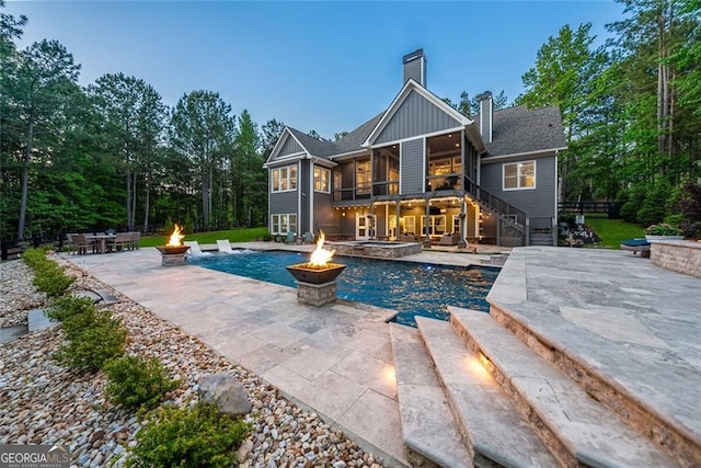 116 Serenity Lake Dr, Alpharetta, GA 30004 - back of house featuring a fire pit, stairway, a chimney, a patio area, and board and batten siding