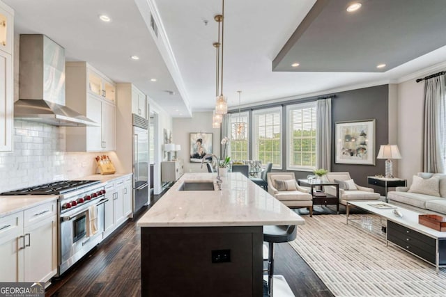 58 Canton St Unit 404, Alpharetta, GA 30009 - kitchen featuring high end appliances, wall chimney exhaust hood, a sink, dark wood-style floors, and recessed lighting