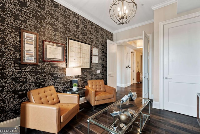 sitting room featuring a chandelier, wood finished floors, baseboards, and crown molding