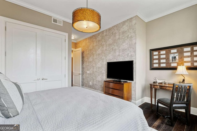 58 Canton St Unit 404, Alpharetta, GA 30009 - bedroom with baseboards, dark wood-type flooring, crown molding, and a closet