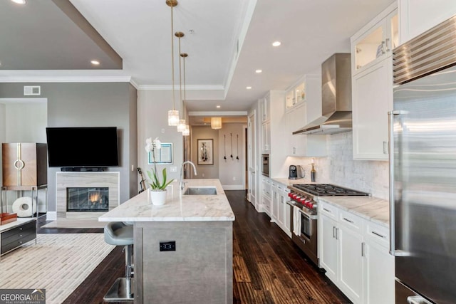 58 Canton St Unit 404, Alpharetta, GA 30009 - kitchen featuring high quality appliances, wall chimney exhaust hood, baseboards, dark wood-type flooring, and white cabinetry