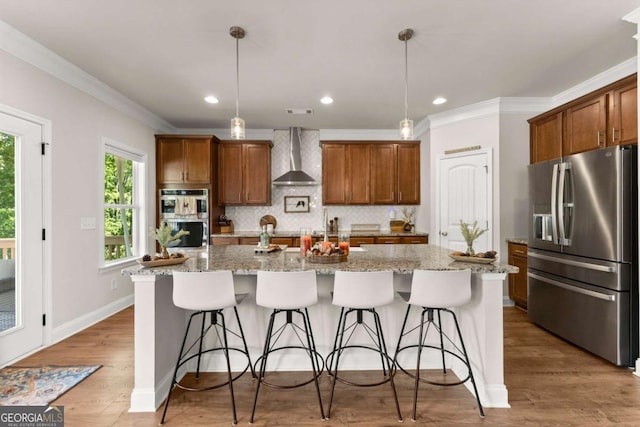 3616 Castoff Ct, Gainesville, GA 30506 - kitchen with appliances with stainless steel finishes, wall chimney range hood, tasteful backsplash, a kitchen breakfast bar, and crown molding