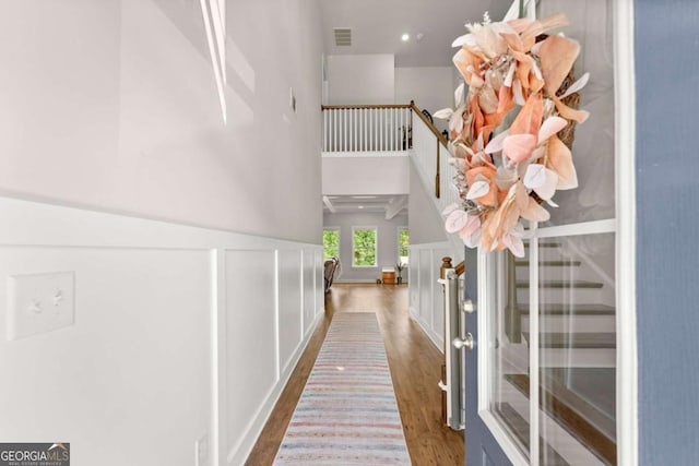 3616 Castoff Ct, Gainesville, GA 30506 - corridor with wood finished floors, a high ceiling, wainscoting, and a decorative wall