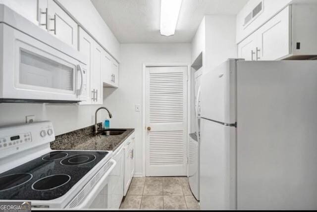 3142 Reeves St SE, Smyrna, GA 30080 - kitchen featuring white appliances, a sink, white cabinets, dark stone countertops, and light tile patterned flooring