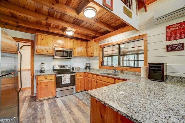 369 Trillium Rd, Suches, GA 30572 - kitchen with appliances with stainless steel finishes, wood ceiling, an AC wall unit, a sink, and light wood finished floors