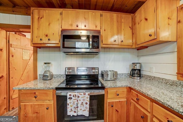 369 Trillium Rd, Suches, GA 30572 - kitchen with appliances with stainless steel finishes, wood ceiling, and light stone countertops