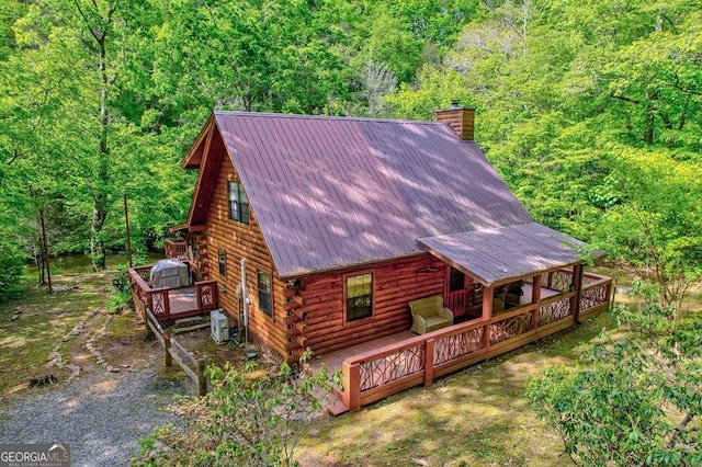 369 Trillium Rd, Suches, GA 30572 - view of front facade featuring log siding, a chimney, a deck, and a wooded view