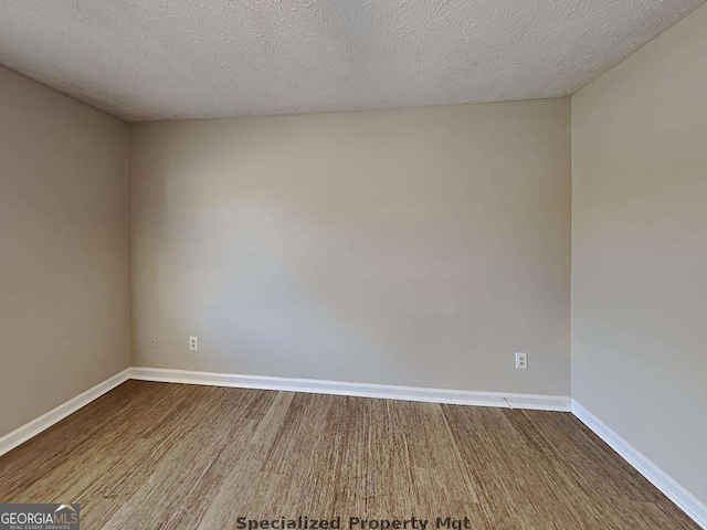 19 Hannon Way, Cartersville, GA 30120 - unfurnished room with baseboards, dark wood finished floors, and a textured ceiling
