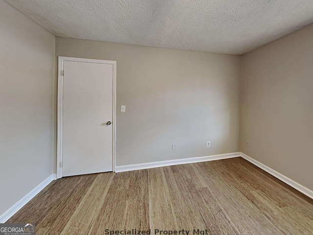 19 Hannon Way, Cartersville, GA 30120 - spare room with wood finished floors, baseboards, and a textured ceiling