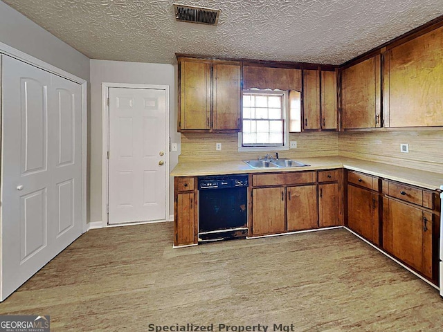 19 Hannon Way, Cartersville, GA 30120 - kitchen featuring dishwasher, a sink, light wood-style floors, light countertops, and a textured ceiling