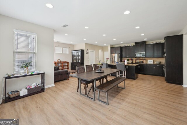 dining area featuring light wood-type flooring, recessed lighting, and baseboards