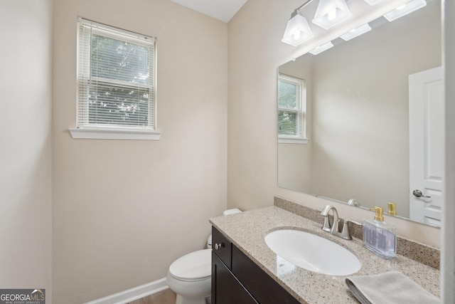 half bathroom with toilet and vanity