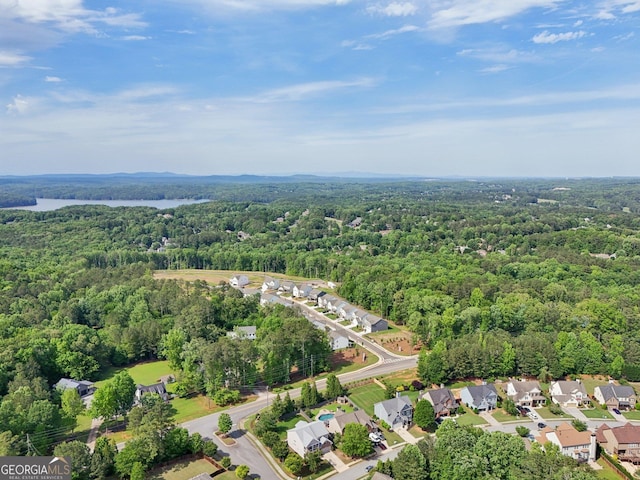 aerial view of property and surrounding area with a heavily wooded area