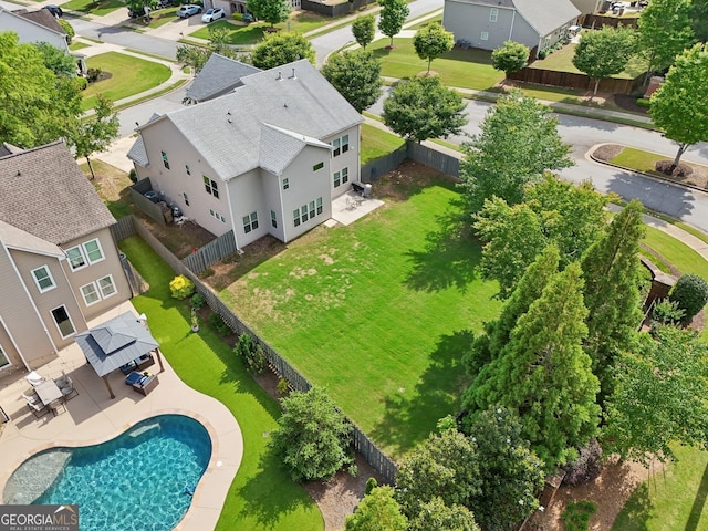 aerial perspective of suburban area featuring a pool