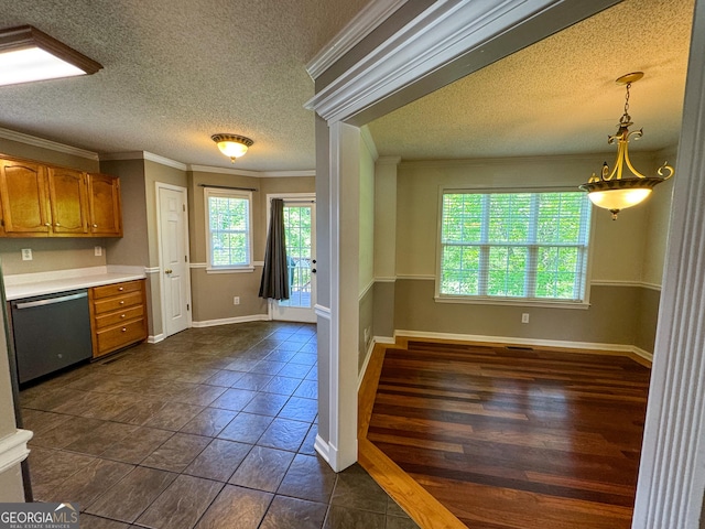 kitchen featuring stainless steel dishwasher, brown cabinets, a textured ceiling, light countertops, and crown molding