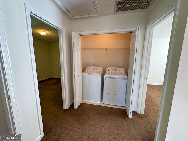 clothes washing area featuring dark carpet and washer and dryer