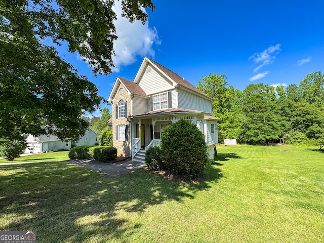 view of front facade with a front lawn and a porch