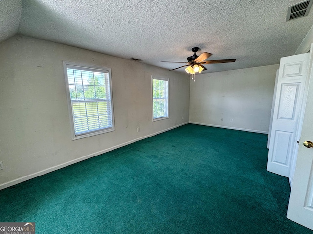 empty room with a ceiling fan, a textured ceiling, carpet flooring, and baseboards
