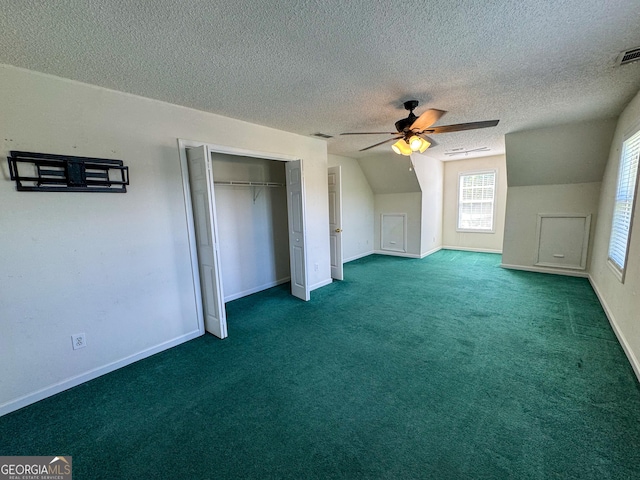 bonus room with a ceiling fan, baseboards, a textured ceiling, lofted ceiling, and carpet flooring