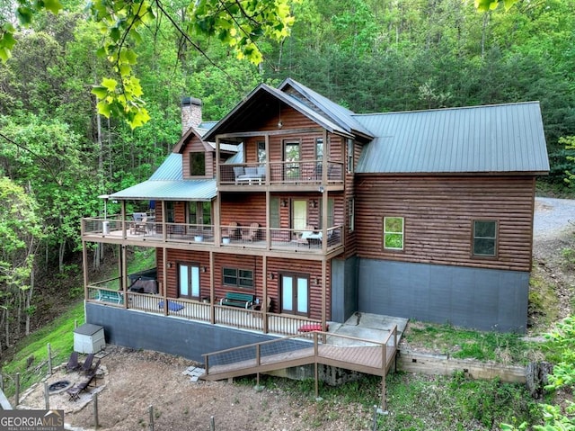 840 Deer Crest Rd, Blue Ridge, GA 30513 - back of house featuring a balcony, metal roof, a chimney, and a wooden deck