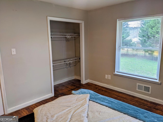 67 Sprayberry Rd, Newnan, GA 30263 - bedroom featuring a closet, baseboards, and dark wood finished floors