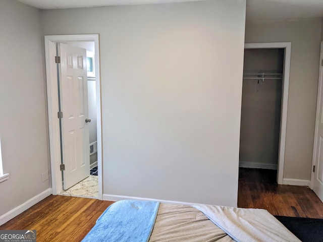 67 Sprayberry Rd, Newnan, GA 30263 - bedroom featuring wood finished floors, baseboards, a closet, and a walk in closet