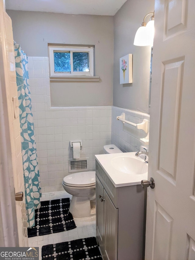 67 Sprayberry Rd, Newnan, GA 30263 - full bathroom with tile walls, toilet, vanity, tile patterned floors, and a shower with shower curtain