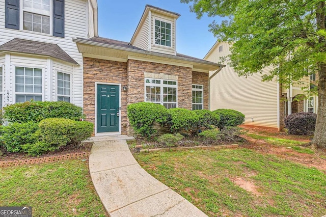 property entrance featuring stone siding