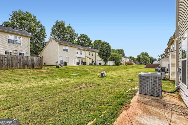 view of yard featuring central AC unit and a residential view