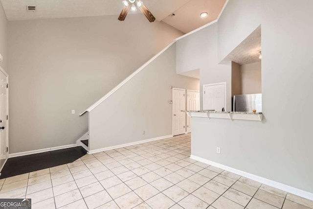 unfurnished living room with a ceiling fan, stairway, high vaulted ceiling, and baseboards