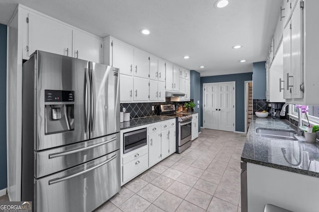 1870 Shoreline Trce, Grayson, GA 30017 - kitchen featuring stainless steel appliances, a sink, recessed lighting, backsplash, and white cabinetry