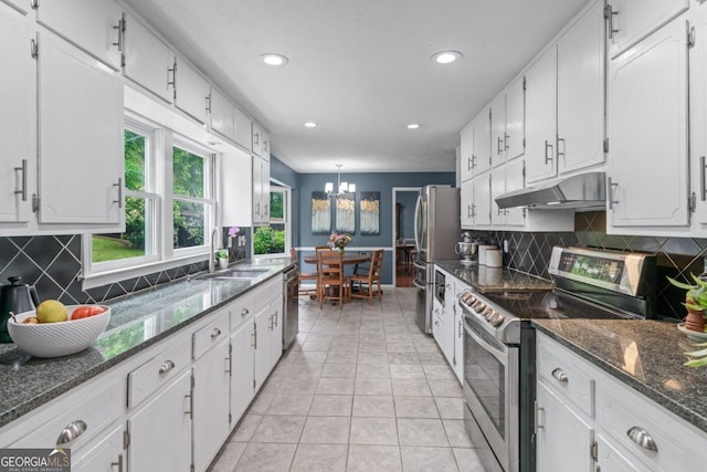 1870 Shoreline Trce, Grayson, GA 30017 - kitchen with appliances with stainless steel finishes, under cabinet range hood, a sink, a chandelier, and white cabinets