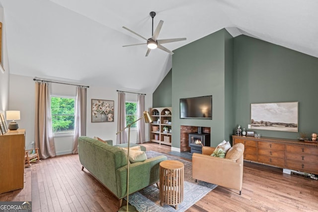 1870 Shoreline Trce, Grayson, GA 30017 - living area featuring ceiling fan, wood finished floors, high vaulted ceiling, and a wood stove
