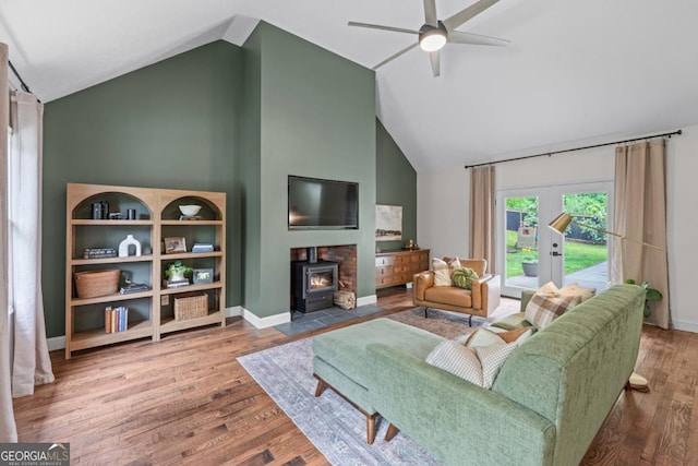 1870 Shoreline Trce, Grayson, GA 30017 - living room with a wood stove, a ceiling fan, high vaulted ceiling, and wood finished floors