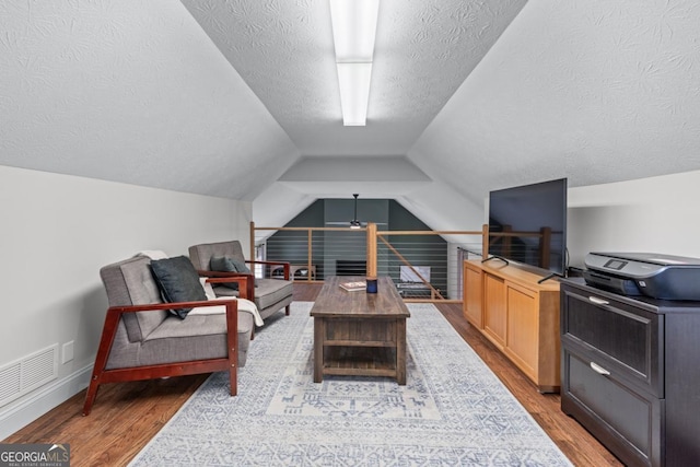 1870 Shoreline Trce, Grayson, GA 30017 - sitting room featuring wood finished floors, a textured ceiling, vaulted ceiling, and baseboards