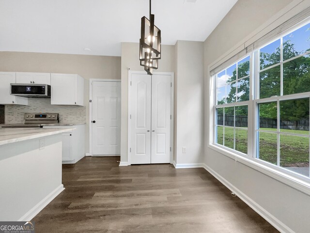 617 Kyles Cir, Hiram, GA 30141 - unfurnished dining area featuring healthy amount of natural light, dark wood-type flooring, and baseboards