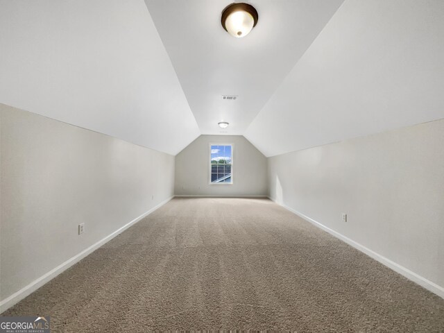 617 Kyles Cir, Hiram, GA 30141 - bonus room featuring vaulted ceiling, baseboards, and carpet