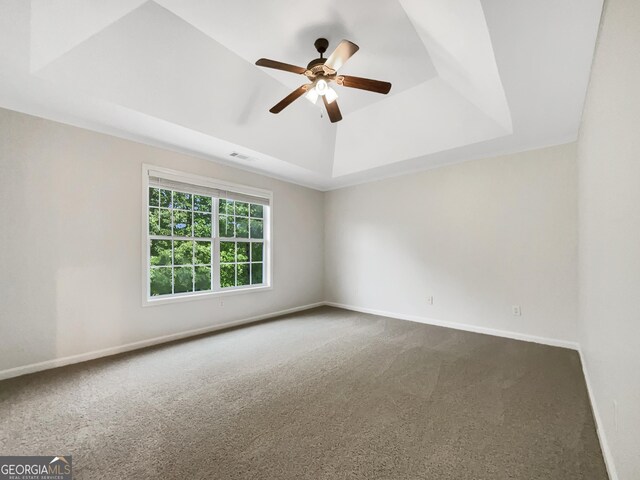 617 Kyles Cir, Hiram, GA 30141 - empty room featuring dark carpet, a raised ceiling, ceiling fan, and baseboards