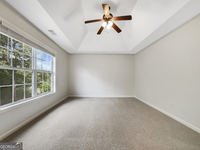 617 Kyles Cir, Hiram, GA 30141 - spare room featuring a tray ceiling, carpet, baseboards, and a ceiling fan