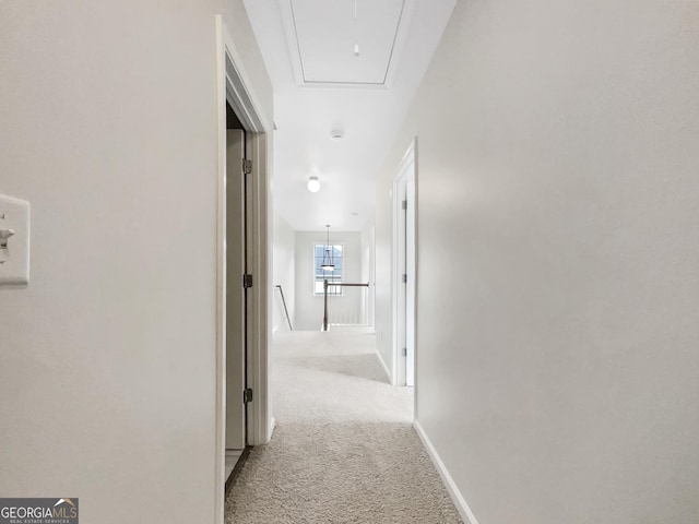 617 Kyles Cir, Hiram, GA 30141 - hallway with attic access, carpet floors, baseboards, and an upstairs landing
