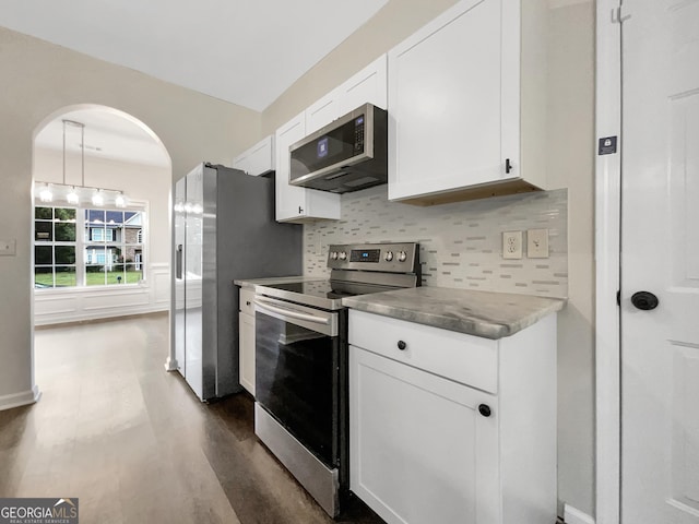 617 Kyles Cir, Hiram, GA 30141 - kitchen featuring stainless steel appliances, dark wood-type flooring, white cabinets, backsplash, and arched walkways