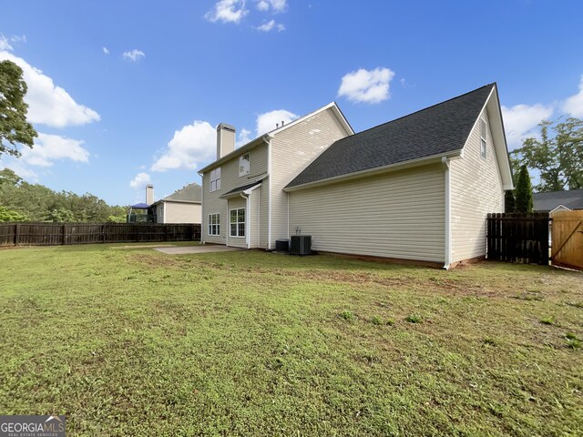 617 Kyles Cir, Hiram, GA 30141 - rear view of property featuring a chimney, a patio, and central AC unit