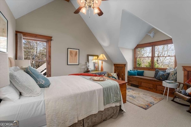 carpeted bedroom featuring vaulted ceiling, multiple windows, access to exterior, and a ceiling fan