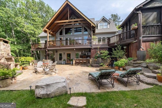 rear view of house with a patio area and a deck