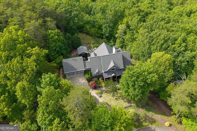 view of subject property with a heavily wooded area