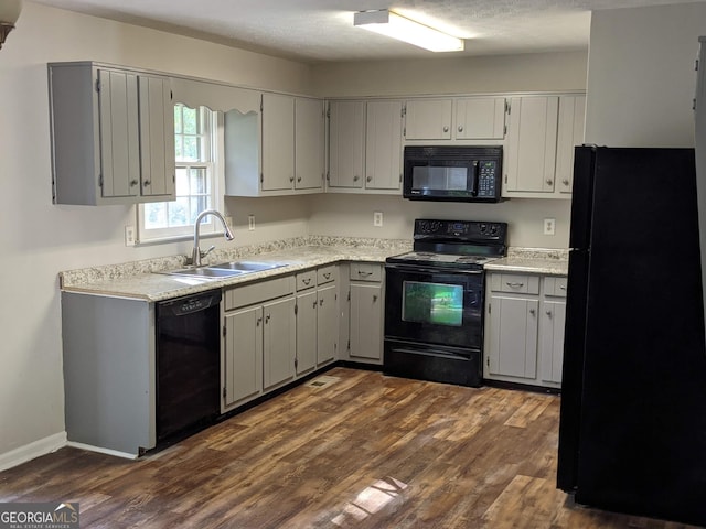 135 Beverly Park Ct, Newnan, GA 30263 - kitchen with black appliances, a sink, dark wood-style floors, and light countertops