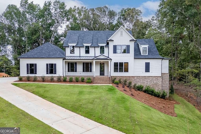 7620 Breeze Bay Rd, Cumming, GA 30041 - modern inspired farmhouse with a porch, a front yard, brick siding, a standing seam roof, and board and batten siding