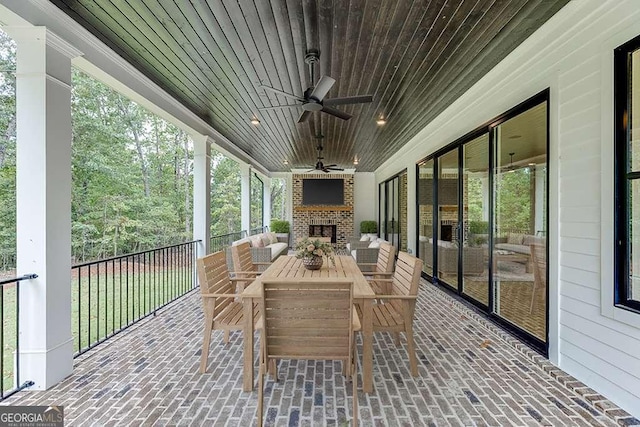 7620 Breeze Bay Rd, Cumming, GA 30041 - sunroom / solarium with an outdoor brick fireplace, a ceiling fan, and outdoor dining space